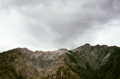 Scenic view of mountains against cloudy sky