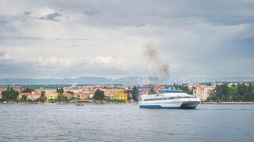 Scenic view of sea against sky in city