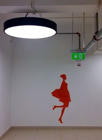 Low angle view of man walking on illuminated wall