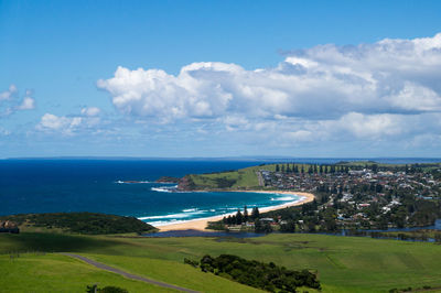 Scenic view of sea and cityscape against sky