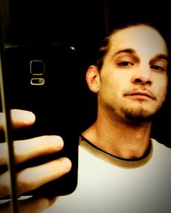 Close-up of young man in darkroom