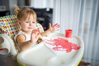 Portrait of cute boy eating food at home