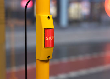 Close-up of yellow sign on pole