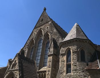 Low angle view of building against clear blue sky