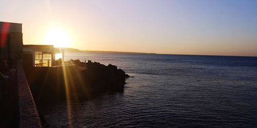 Scenic view of sea against clear sky during sunset