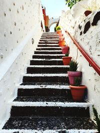 Low angle view of steps amidst buildings