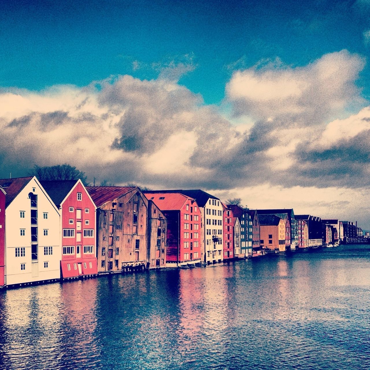architecture, built structure, building exterior, sky, waterfront, water, cloud - sky, cloudy, residential structure, cloud, residential building, house, city, river, building, reflection, residential district, outdoors, no people, overcast