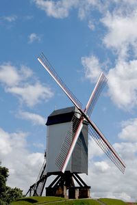 Low angle view of traditional windmill against sky