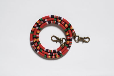 Close-up of multi colored umbrella against white background