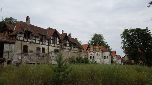 Buildings against cloudy sky
