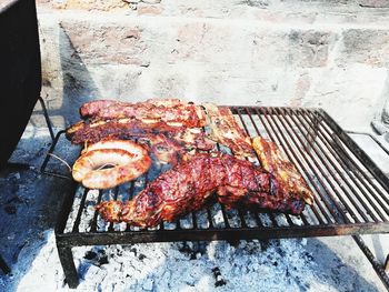 High angle view of meat on barbecue grill