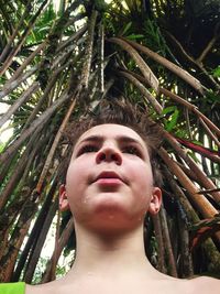 Low angle view of young woman looking up