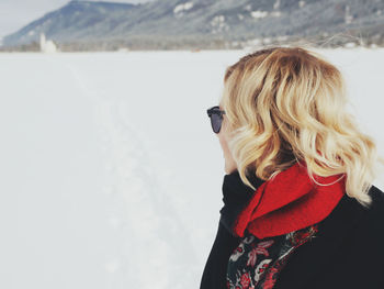 Rear view of woman standing in snow