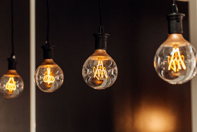 Close-up of illuminated light bulb hanging