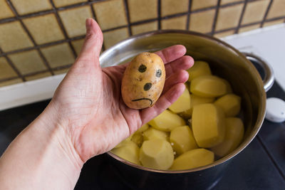 Close-up of hand holding food in bowl