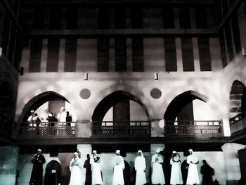 People in corridor of cathedral