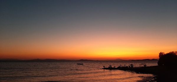 Scenic view of sea against clear sky during sunset