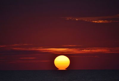 Scenic view of sea against romantic sky at sunset