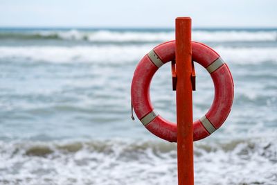 Close-up of red umbrella on beach