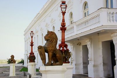 Statue outside temple against sky