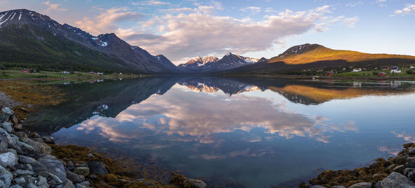Panoramic view of mountains reflecting on calm lake during winter