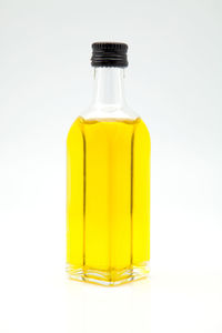 Close-up of yellow bottle against white background