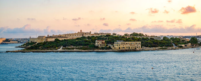 View over the manoel island at sunset from sliema, malta