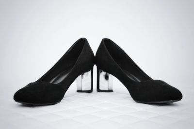 Close-up of shoes on floor against white background