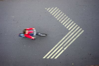 High angle view of person riding bicycle on road