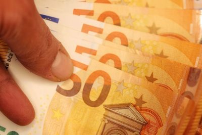 Close-up of hand holding paper