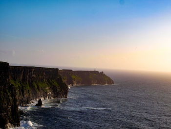 Scenic view of sea against clear sky during sunset