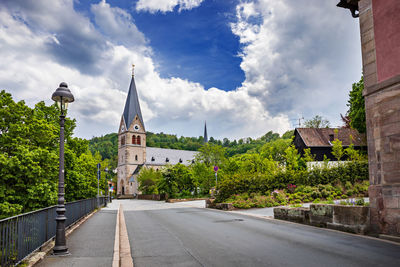 Street amidst buildings in city against sky