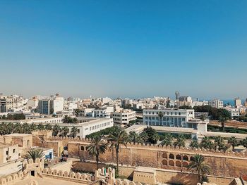 High angle view of buildings against clear blue sky