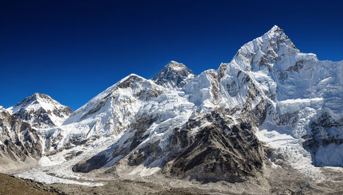 Snowcapped mountains against clear blue sky