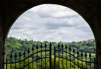 Panoramic view of gate and plants against sky