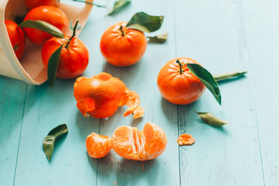 High angle view of oranges on blue table