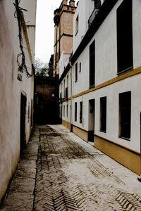 Empty alley amidst buildings