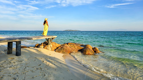 Rear view of woman walking on beach