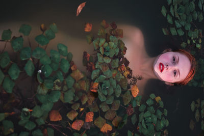 Directly above shot of woman lying in lake