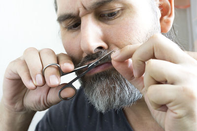 Close-up portrait of man holding hands