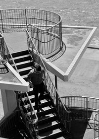 High angle view of woman standing on staircase