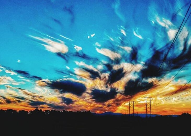 silhouette, sunset, sky, blue, beauty in nature, scenics, tranquil scene, tranquility, cloud - sky, nature, cloud, idyllic, dramatic sky, dusk, orange color, landscape, low angle view, outdoors, no people, majestic