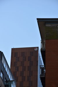 Low angle view of building against clear blue sky