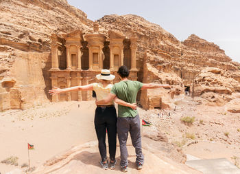 Rear view of man standing at desert