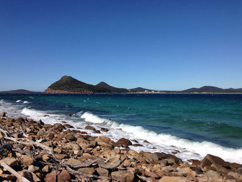 Scenic view of sea against clear blue sky