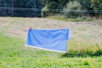 Cloth hanging on a clothesline on blue sky background.