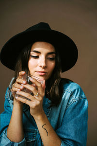 Portrait of beautiful woman drinking water