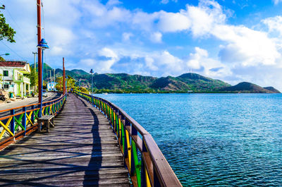 Scenic view of jetty against cloudy sky