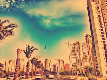 View of city buildings against cloudy sky