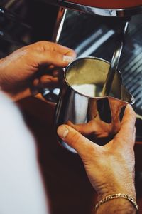 Close-up of hand holding coffee cup